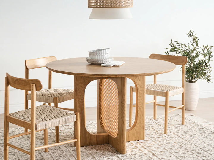 Wooden dining table with chairs in a bright room