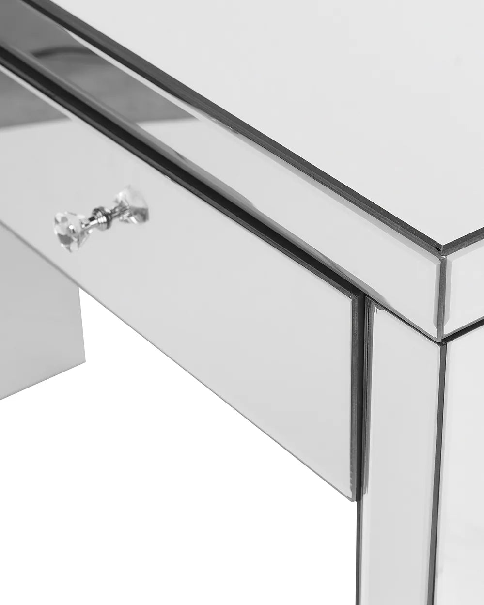 Close-up of a mirrored furniture piece with a silver handle on a white background