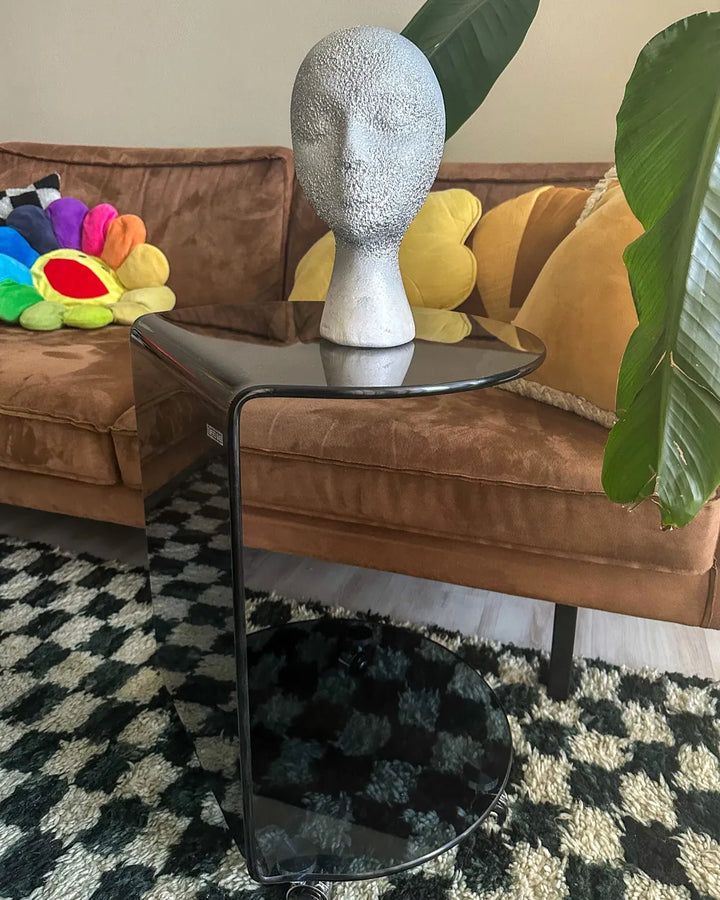 Living room with a brown sofa, colorful toys, and a black side table.