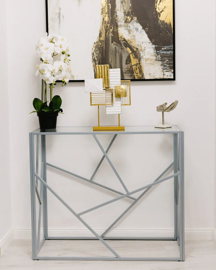 Modern side table with decorative items against a white wall