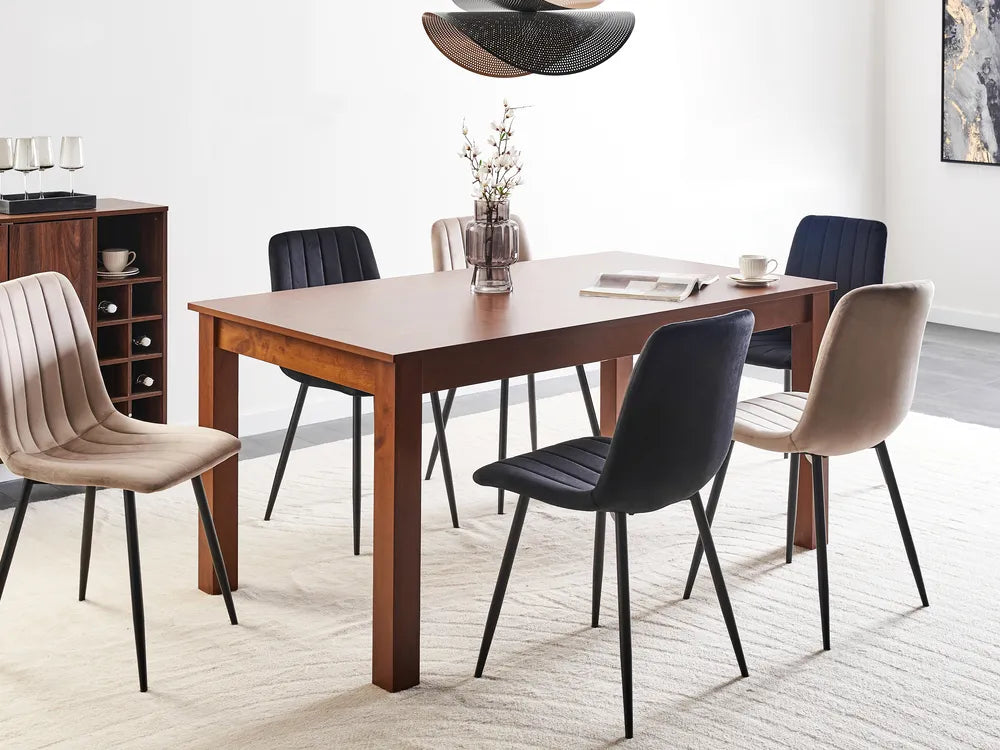 Dining room with wooden table and modern chairs in a well-lit room.