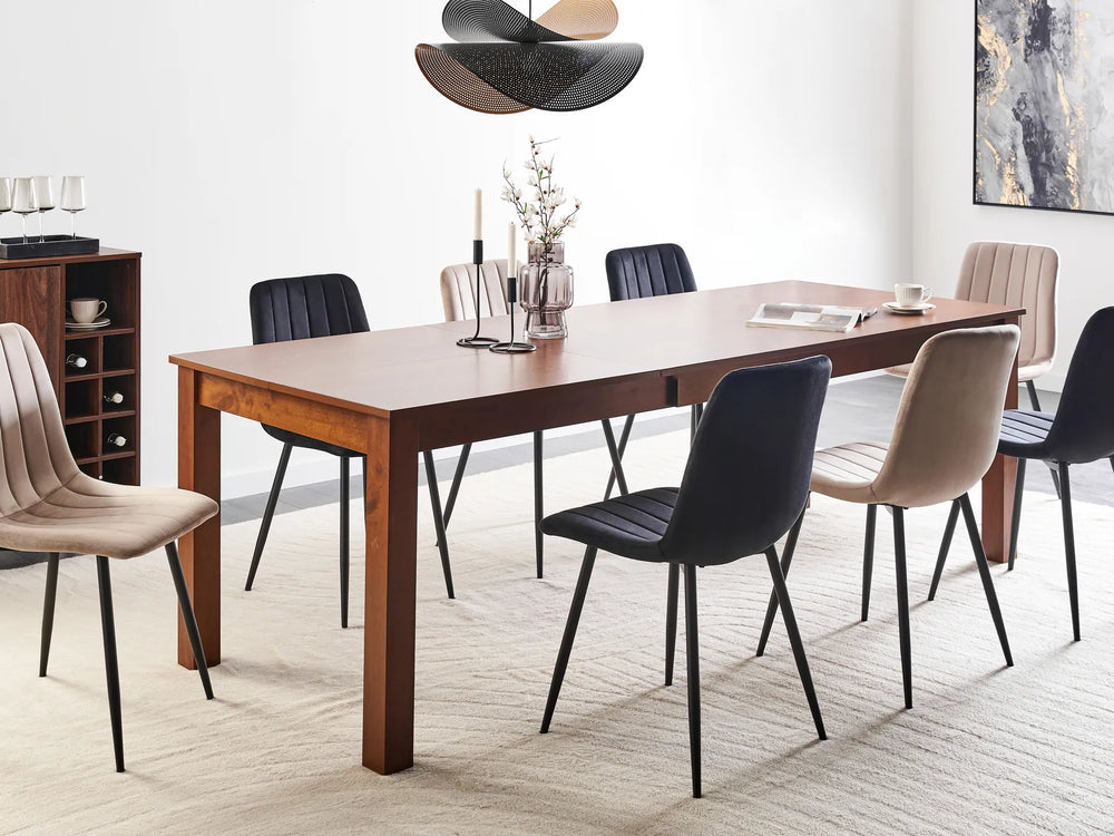 Dining room with a wooden table and modern chairs in a well-lit room.