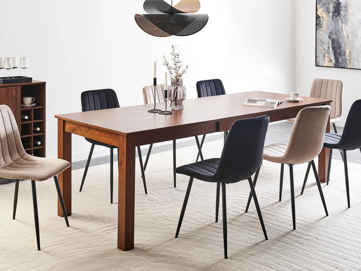 Dining room with a wooden table and modern chairs in a well-lit room.