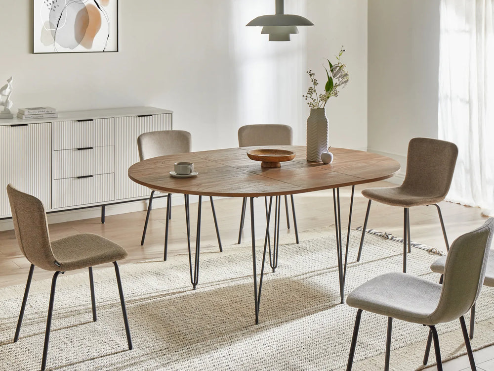 Dining room with a wooden table and chairs in a modern interior setting.