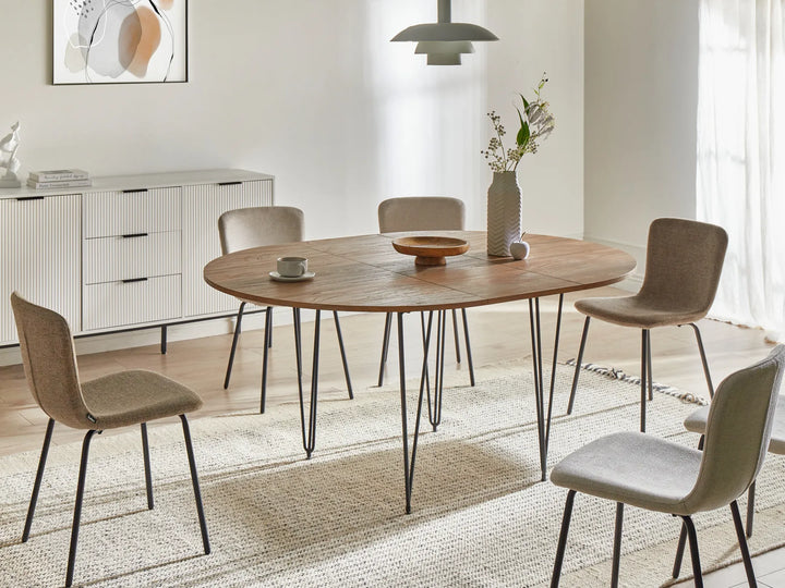 Dining room with a wooden table and chairs in a modern interior setting.