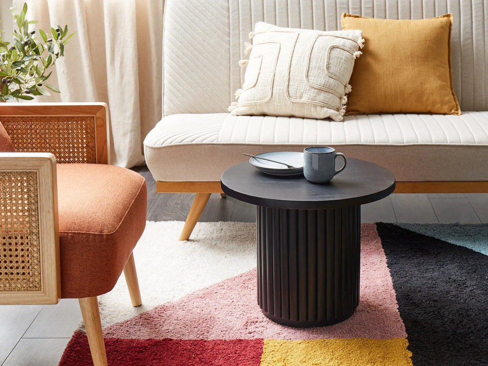 Living room with a sofa, armchair, coffee table, and decorative pillows.