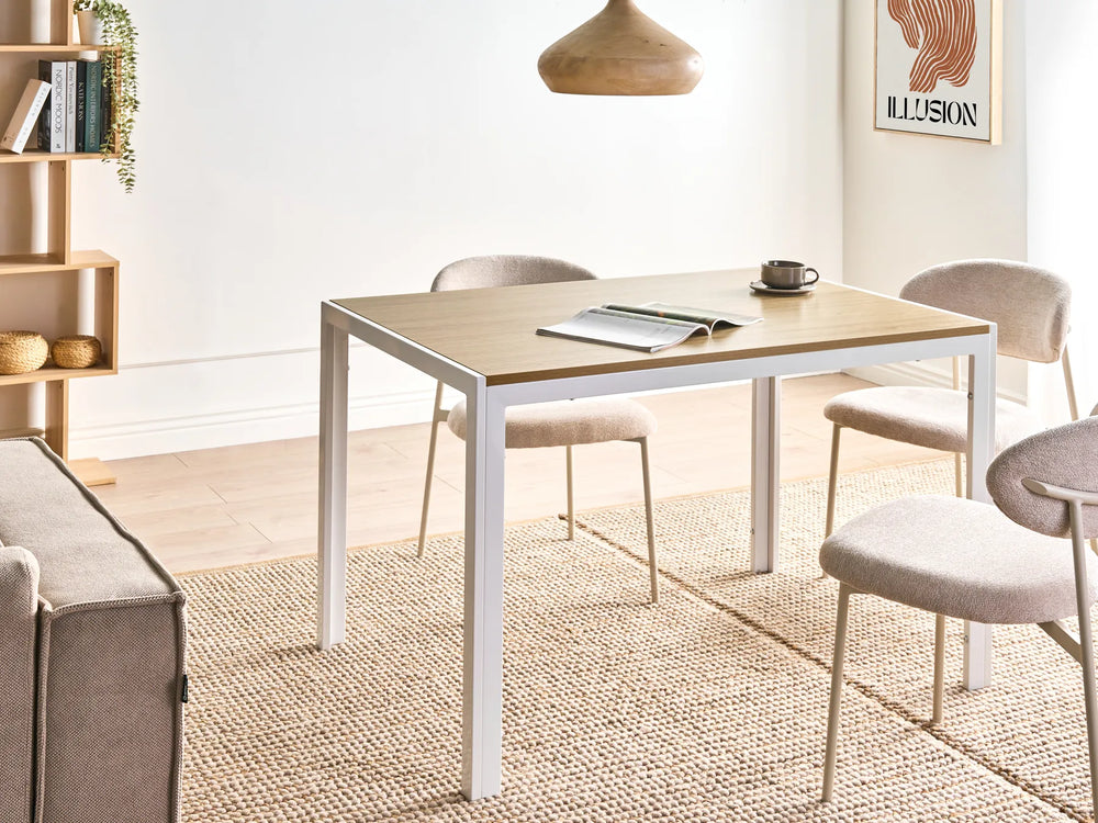 Dining area with a table, chairs, and a couch in a well-lit room.