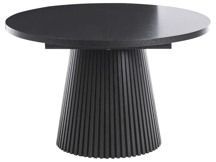 Black round table with a ribbed cylindrical base on a white background