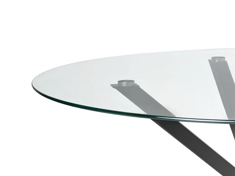 Glass dining table with metal legs on a white background